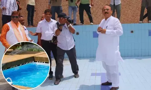 Minister Ashish Sood inspecting the swimming pool in a Delhi school