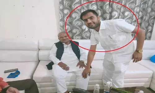 Accused Bhavesh Jain touching the feet of the MLA