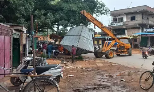 Administrative staff removing encroachment