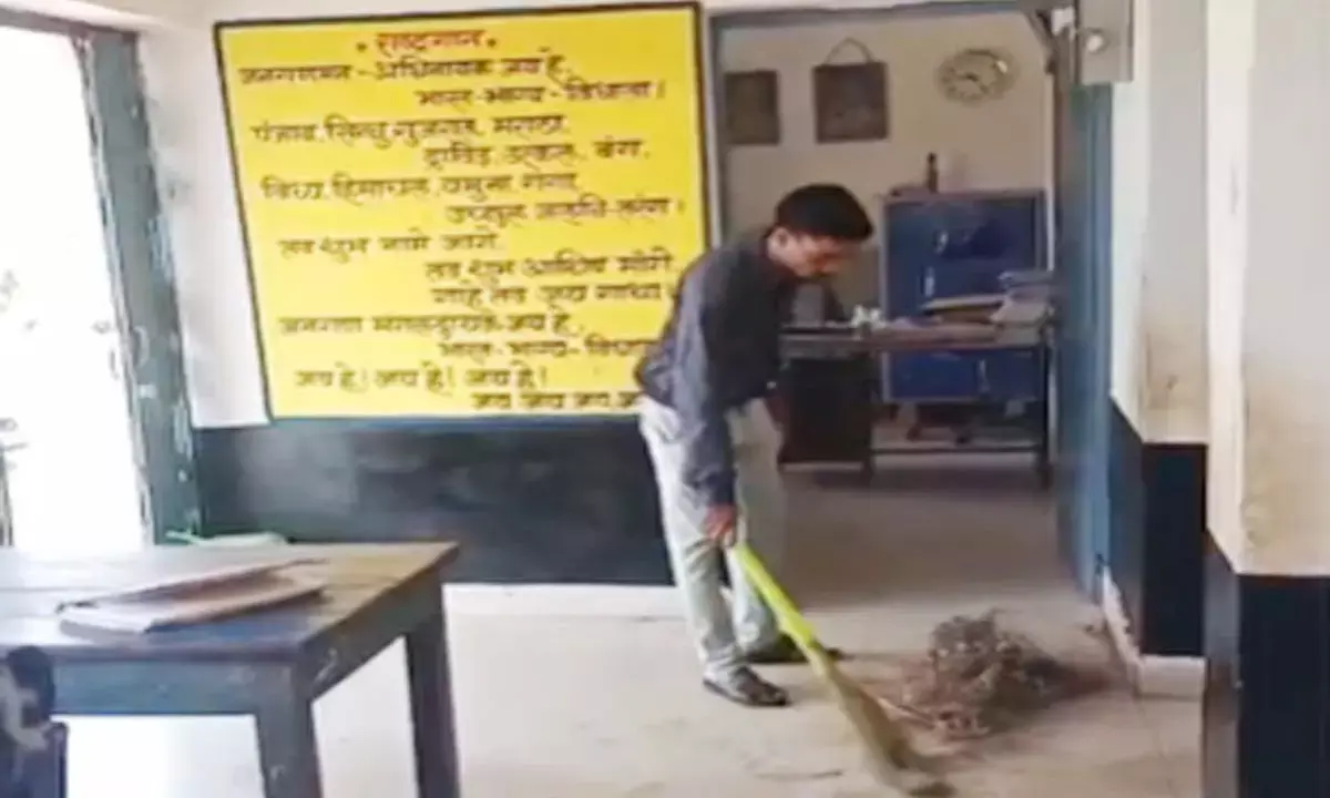 assistant teacher sweeping