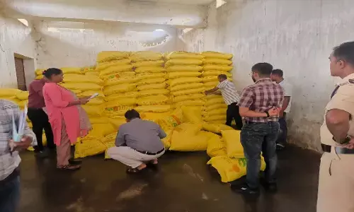 officials inspecting the fertilizer