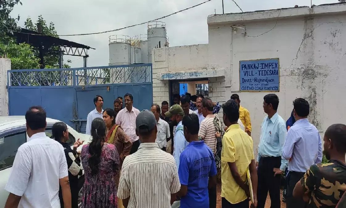 Officials standing outside the factory