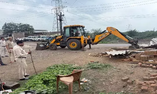 Policemen running bulldozers on shops of drug dealers