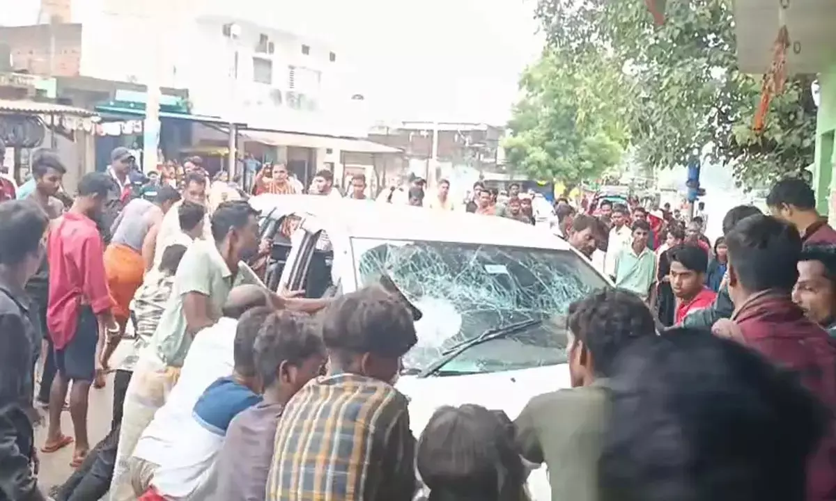 Villagers reprimanding the driver