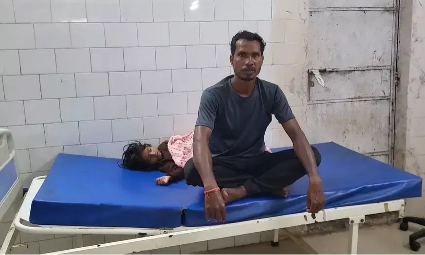 baby girl lying on bed