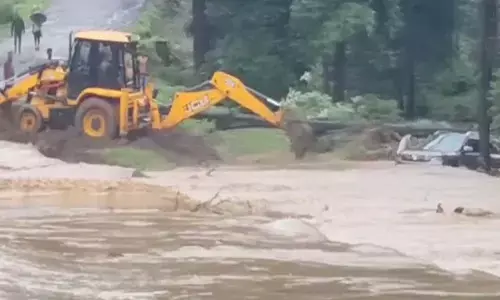Pulling out a car swept away in the flood with the help of a JCB Pulling out a car swept away in the flood with the help of a JCB