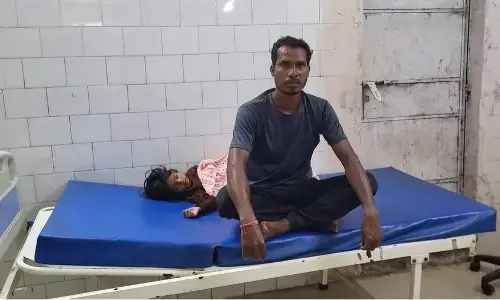 baby girl lying on bed