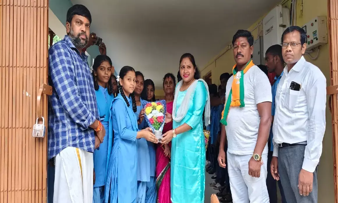 Girls presenting a flower bouquet to Advocate Deepika Shori, member of the State Womens Commission