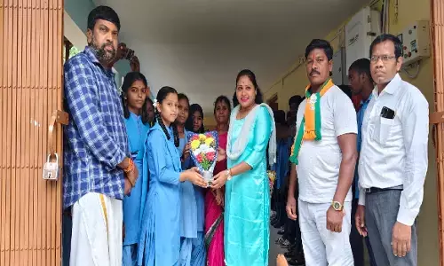 Girls presenting a flower bouquet to Advocate Deepika Shori, member of the State Womens Commission