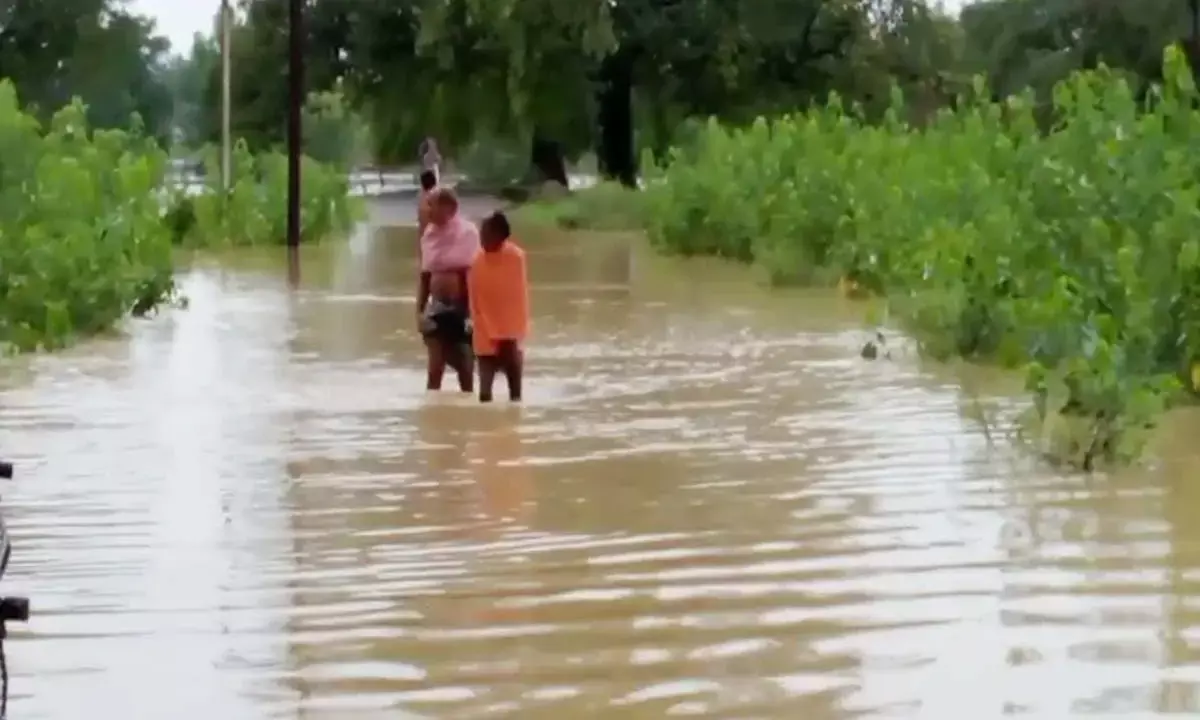 Villagers crossing the drain risking their lives
