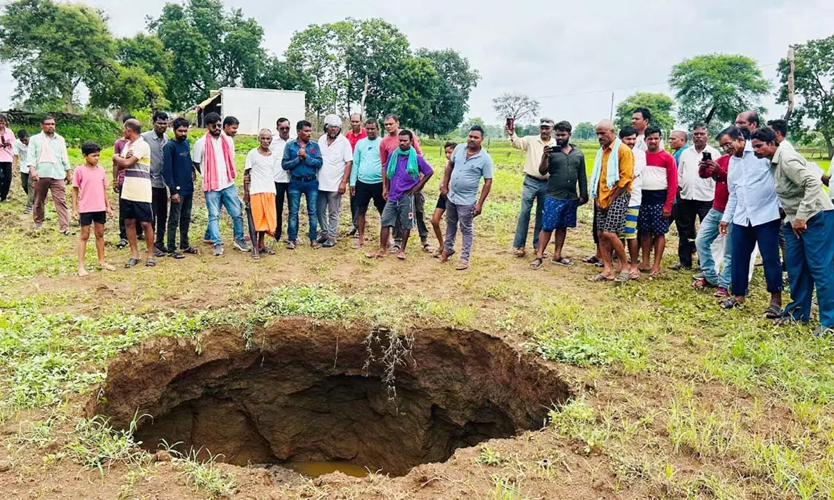 Crowd of villagers gathered to see the pit Crowd of villagers gathered to see the pit