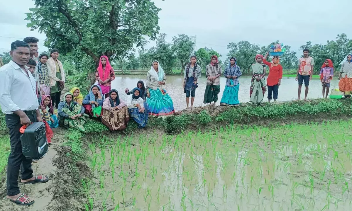 Villagers planting saplings and listening to Mann Baat