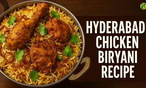 Hyderabadi Chicken Biryani, served in a single pot, featuring spicy chicken, fried onions, and aromatic basmati rice, garnished with coriander.